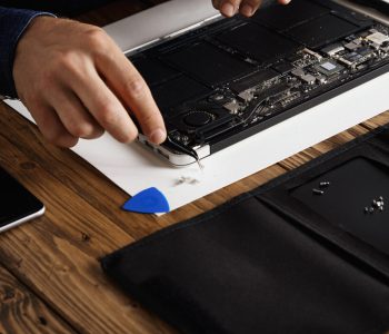 hand that uses angled esd tweezers remove dust from electronic boards broken slim computer laptop fix it make work again scaled