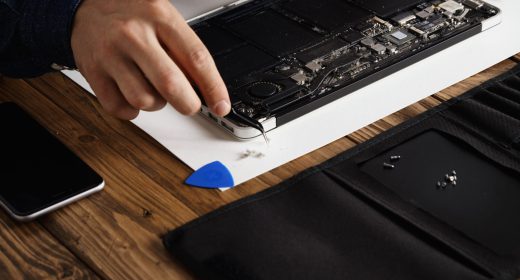 hand that uses angled esd tweezers remove dust from electronic boards broken slim computer laptop fix it make work again scaled