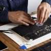 master uses small suction cup change battery cells from broken laptop repair clean it his laboratory with specific toolkit wooden table around 346278 1804.jpg