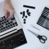 young woman cleaning her laptop key board scaled