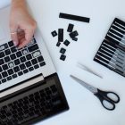 young woman cleaning her laptop key board 23 2149402391